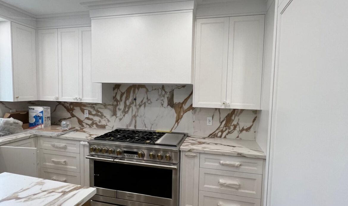 White kitchen renovation with custom cabinetry and stone backsplash in the GTA