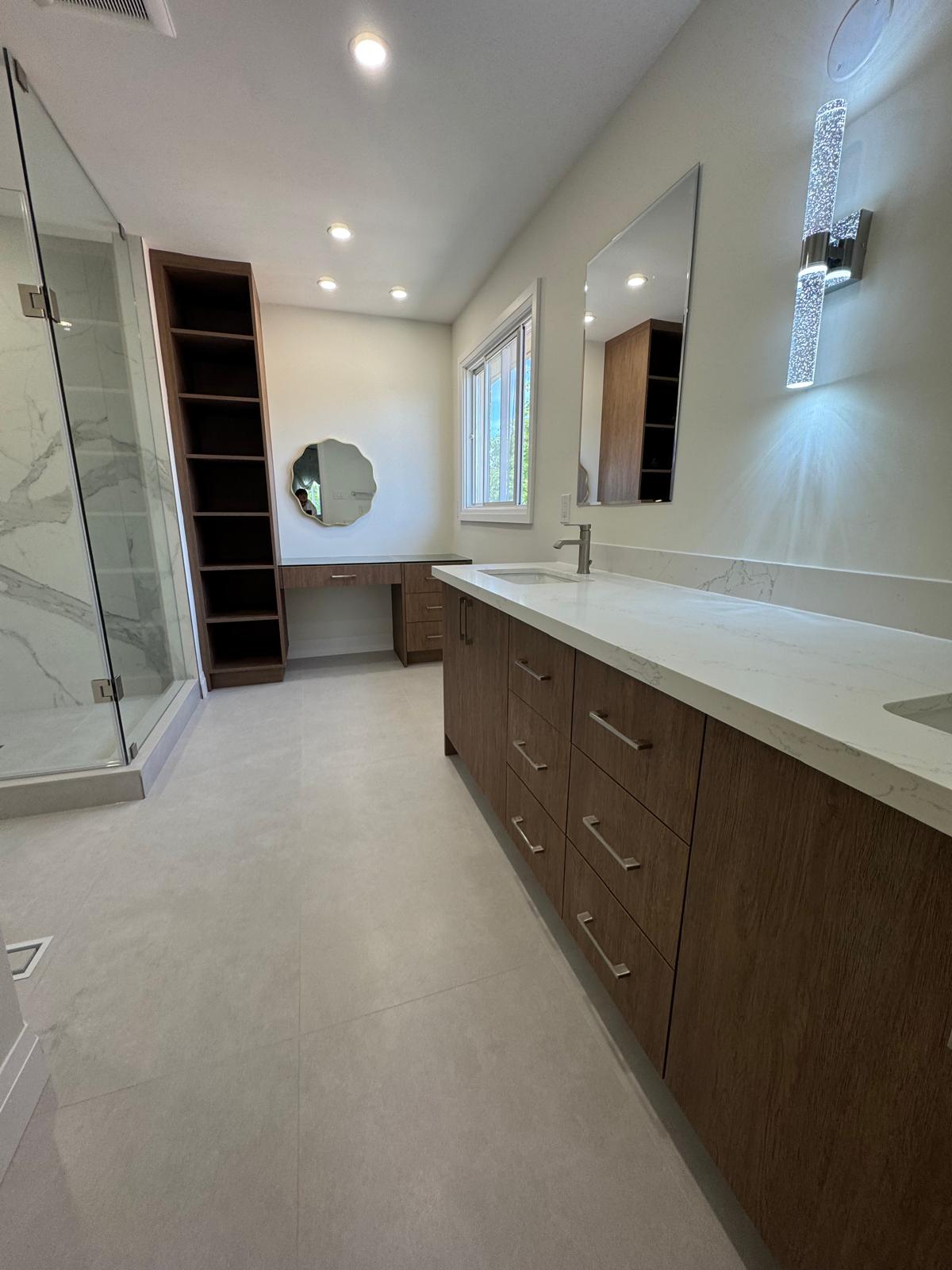 Wood-tone vanity, tall storage and mirrors in the same Richmond Hill bathroom