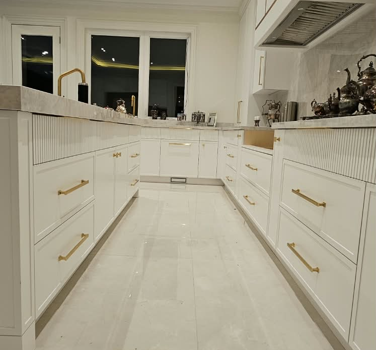 Luxury white kitchen renovation with gold accents in the GTA