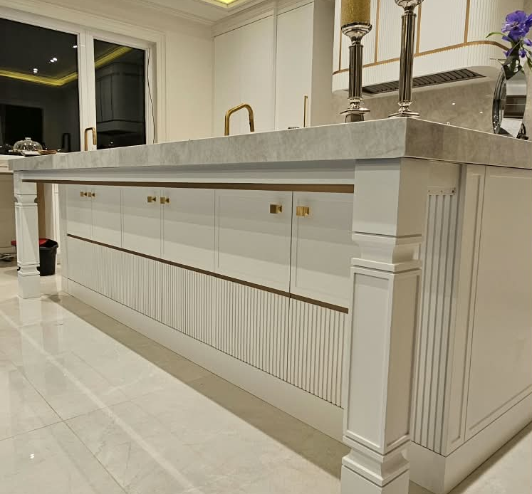 Custom white kitchen island with gold hardware in the GTA