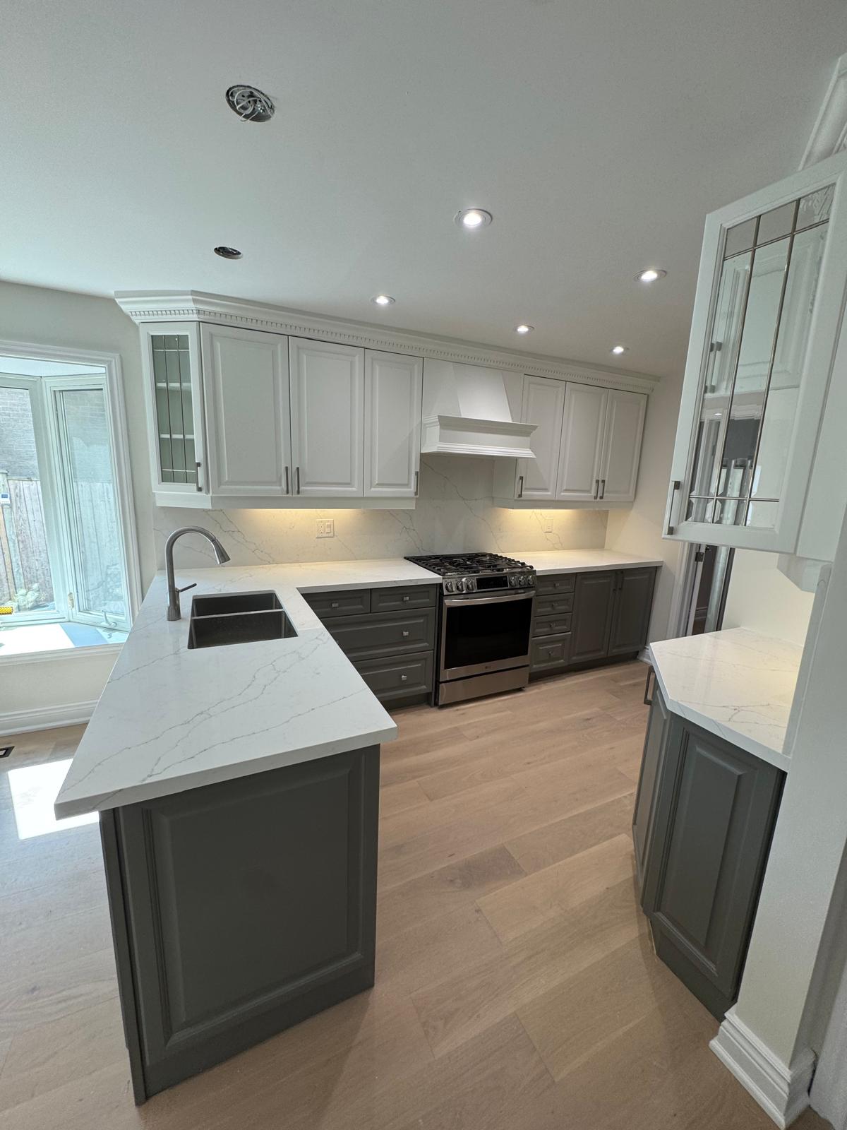Sink, range and contrasting cabinetry in the Aurora kitchen renovation